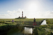 Backlit Westerheversand lighthouse, Westerhever, Wadden Sea National Park, Eiderstedt peninsula, North Frisian Islands, Schleswig-Holstein, Germany, Europe