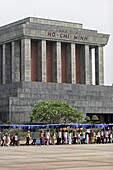 Big crowd queues forming line to file through the Ho Chi Minh mausoleum Hanoi Vietnam