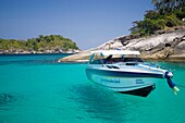 Speed boat appears to hang in clear blue tropical water Similan Islands Thailand