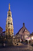 fountain Schöner Brunnen and Church of Our Lady, illuminated at night, Nuremberg, Germany