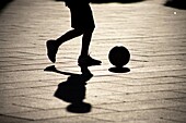 A boy plays soccer in the main square of Merida, Badajoz province, Extremadura region.