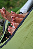 Feet Sticking Out From A Tent, Camping Family Just Waking Up