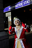 Man wearing a king costume in front of Westminster station in London,England,United Kingdom