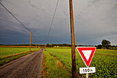 France, Normandy, country road and stormy weather
