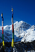 Nepal Annapurna ring prayers'flags in front of the GANGAPURNA PEAK from  the village of MANANG