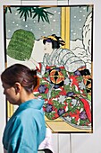 Japan,Tokyo,Ginza,Woman Walking Past Kabuki Advertising Posters