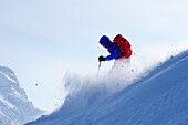 Young man downhill skiing from mount Sulzspitze, Tannheim Mountains, Allgaeu Alps, Tyrol, Austria