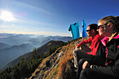 Young couple resting on summit of Risserkogel, Bavarian Prealps, Mangfall Mountains, Bavaria, Germany