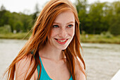 Young woman on the Isar riverbank, Munich, Bavaria, Germany