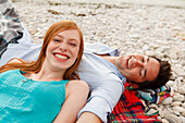 Young couple on bank of Isar river, Munich, Bavaria, Germany