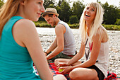 Young people on Isar riverbank, Munich, Bavaria, Germany