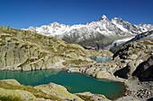 Lake Lac Blanc with Chalet du Lac Blanc, Mont Blanc range in the background with Aiguille du Chardonnet, Aiguille d' Argentiere, Aiguille Verte and Grand Dru, Mont Blanc range, Chamonix, Savoy, France
