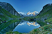 Grand Combin, Combin de Corbassiere and Petit Combin reflecting in a mountain lake, Pennine Alps, Valais, Switzerland