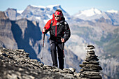 A man hiking, mountaineering at Hohtuerli, pass close to Bluemlisalphütte, Kandertal, in the background Wildstrubel and Diablerets mountains, Bernese Oberland, Canton of Bern, Switzerland
