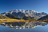 Sella range reflecting in a mountain lake, Val Gardena, Dolomites, UNESCO World Heritage Site Dolomites, South Tyrol, Italy