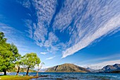 High altitude cirrus cloud streaks over lake Wanaka, South Island, New Zealand