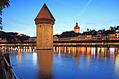 Switzerland, Canton Lucerne, Lucerne, Chapel Bridge and water tower at dusk. Switzerland, Canton Lucerne, Lucerne, Chapel Bridge and water tower at dusk