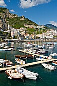 Boats in the harbour and a view of the town of Amalfi on the Gulf of Salerno in southern Italy