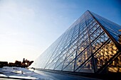 Glass pyramid entrance in front, Palais du Louvre or Louvre Palace museum in the evening light, Paris, France, Europe