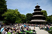 People sitting in the beer garden at Chinese Tower in the English Garden in Munich
