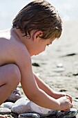 Blond boy playing at the beach, Crete, Greece