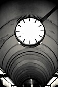 Empty clockface in a deserted walkway tunnel in Stockholm, Sweden
