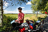 Mid adult man on cycling tour, Goehren, Island of Ruegen, Mecklenburg-Western Pomerania, Germany