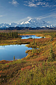Scenic view of tundra ponds and Fall colors with Mt. Mckinley in the background, Denali National Park, Alaska