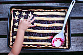 Fourth of July Blueberry Pie With Child's Hand