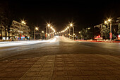 The major city of the Republic of Dagestan at night. A bridge over railroad lit up. Deserted street.