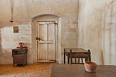 Room in an adobe building with furnishings, at  Mission La Purisima State Historic Park, Lompoc, California, Founded in 1787, the eleventh mission of the twenty-one Spanish Missions established in California