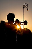 Havana, Cuba, Silhouette Of Man Playing Trumpet At Sunset