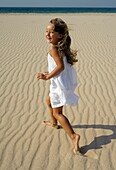 Young Girl Running On Beach