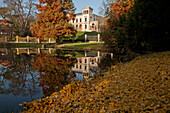 Villa Loebbecke, guesthouse of the University near a pond surrounded by autumn colorBrunswick, Lower Saxony, Germany