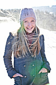 Young woman standing in snowfall