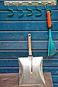 Shovel and cultivator, garden instruments on the blue wall, Vienna, Austria