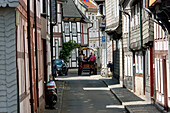 Horse cart tour on a street with half-timbered buildings, Goslar, Germany