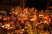 Celebration of DÃ­a de los Muertos, the Day of the Dead at the TzurumÃºtaro cemetery. People decorate the graves of their loved ones with offerings of reeds, flowers, particularly marigolds (cempoalxÃ³chitl or zempasuchil), bread of the dead (pan de muert