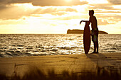 Hawaii, Maui, Makena, Skimboarder silhouette at sunset