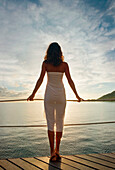 French Polynesia, Moorea, Attractive young woman standing on a dock.