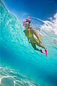 French Polynesia, Moorea, Woman free diving in turquoise ocean.