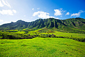Hawaii, Oahu, View of Kaaawa valley and Kualoa Ranch with the Koolau Mountain range in background.