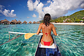 French Polynesia, Bora Bora, Female kayaker enjoying a day on the water.