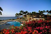 Hawaii, Lanai, Manele Bay Hotel, Pool area with bouganinvillea, ocean view.