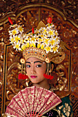 Indonesia, Bali, Legong Dancer young girl in traditional costume, holding fan A61C