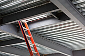 Commercial building under construction. Steel frame construction of the roof, with metal decking. A ladder and roof hatch., Seattle, Washington, USA. Commercial Construction Project