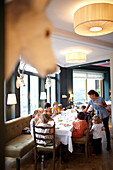 Kids having lunch in the restaurant of Hotel Haus Hirt, Bad Gastein, St. Johann im Pongau, Salzburg, Austria