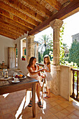 Mother and daughter at loggia, Algaida, Mallorca, Balearic Islands, Spain