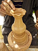 Tunisian potter using clay to make a candlestick, Djerba, Tunisia