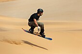 Sand boarding in the dunes of the Namib Desert near the coastal town of Swakopmund has become very popular  Swakopmund, Namibia